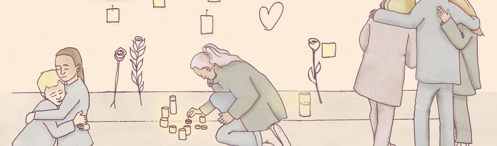 Sörjande människor som tänder ljus och kramas vid minnesplats för ett terrordåd.