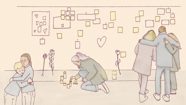 Sörjande människor som tänder ljus och kramas vid minnesplats för ett terrordåd.